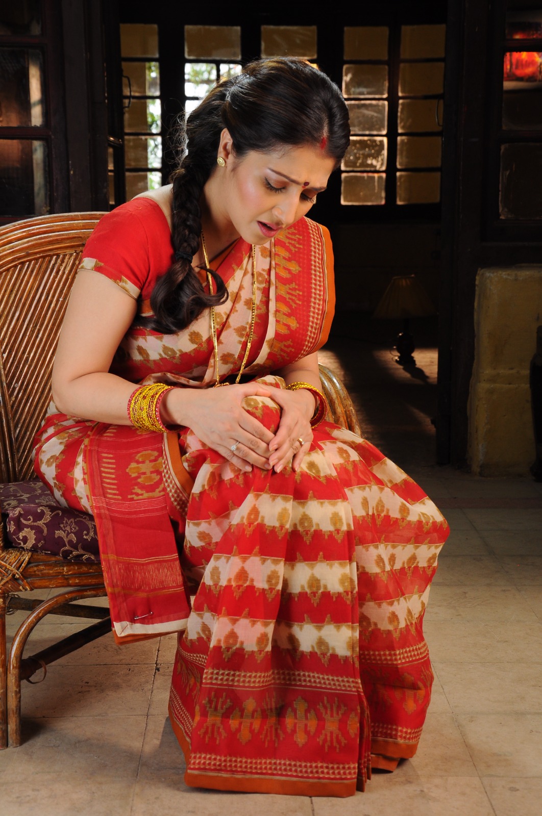 Seated woman holding her knee with both hands