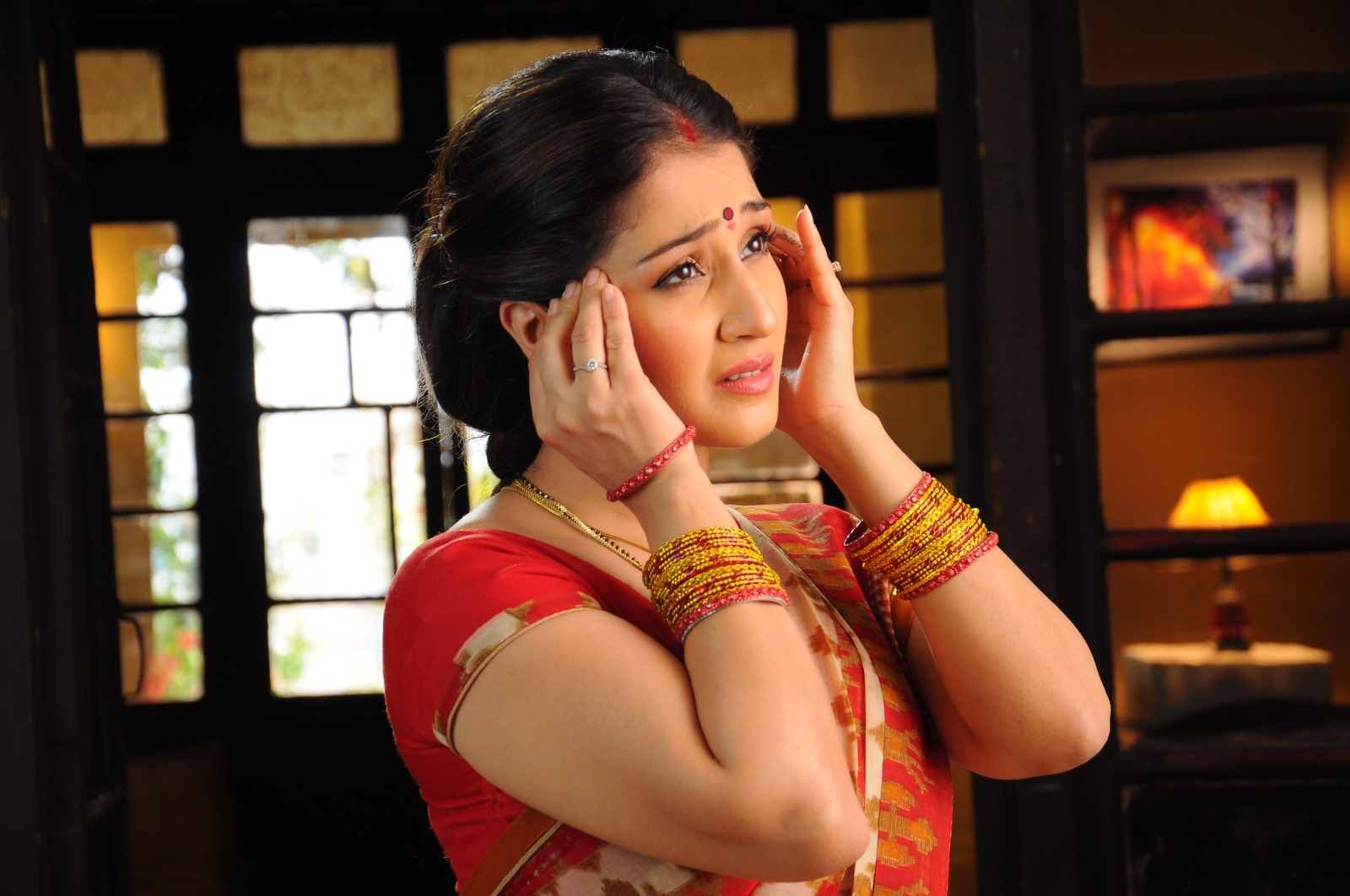 Woman gently holding both sides of her temples
